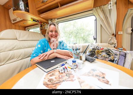 JO Scott, une artiste commerciale renommée, abandonne son studio pour améliorer l'équilibre entre vie professionnelle et vie privée. Travaillant n'importe où dans son état de l'art, Connected motorhome Banque D'Images