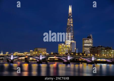 Photo nocturne de London Skyline avec Shard et bateau sur la Tamise Banque D'Images