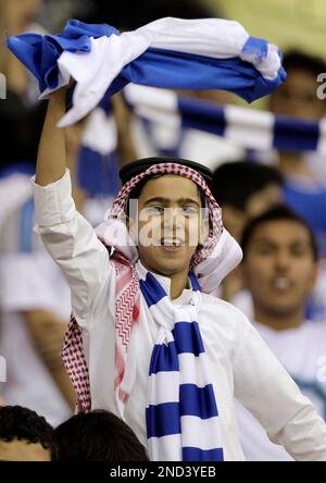 An Al-Hilal fan cheers for his team during the AFC champions league quarterfinal soccer match between Al-Hilal and Al Gharafa at King Fahd Stadium in Riyadh, Saudi Arabia, Wednesday, Sept. 15, 2010. (AP Photo/Hassan Ammar)
