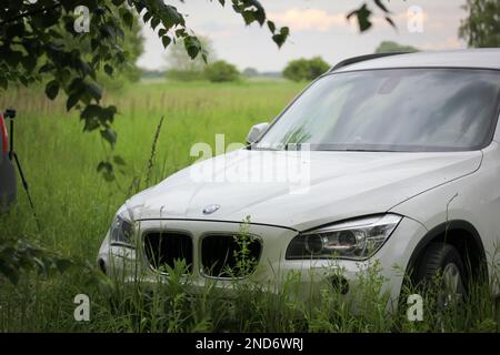 Kiev, Ukraine. 1 mai 2021 SUV blanc dans la nature. Conduite dans la nature, dans les bois, hors route. Nouvelle voiture pour voyager. BMW X1. Transport moderne Banque D'Images