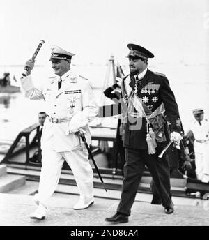 Hand Goring Field Marshal Hermann Goering, left, talks with Lieutenant Commander ...