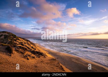 Un coucher de soleil post-tempête depuis les dunes de sable à la plage de Marina State en Californie Banque D'Images