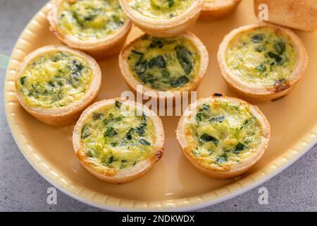 Mini quiches aux épinards pour le brunch de Pâques, quiche florentine Banque D'Images