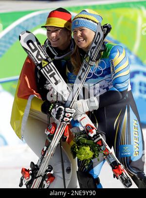 Germany's Maria Riesch, left, winner of the Women's super combined event, poses with bronze medal's winner Anja Paerson of Sweden, at the Vancouver 2010 Olympics in Whistler, British Columbia, Thursday, Feb. 18, 2010. (AP Photo/Sergey Ponomarev)