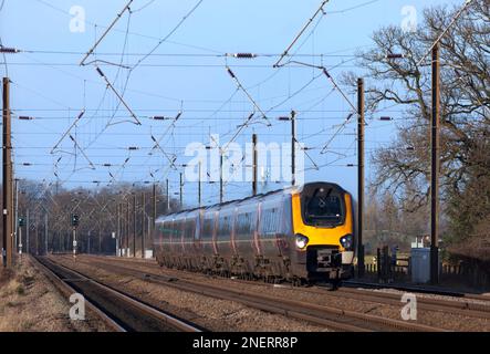 Arriva CrossCountry trains classe 221 diesel voyager train 221141 + classe 220 220012 sur la ligne principale électrifiée de la côte est à Thirsk Banque D'Images