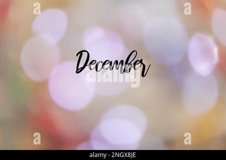 Un arrière-plan flou et coloré avec le nom 'December' en anglais écrit dessus. Banque D'Images