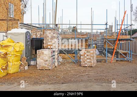 Échelle d'accès au bois en place par un sous-traitant spécialisé en échafaudage pour les briques pour travailler sur des murs de briques extérieurs et de cavités de blocs Angleterre Royaume-Uni Banque D'Images