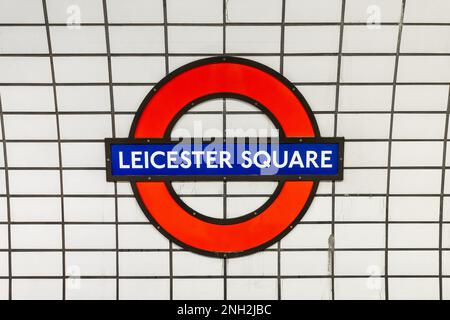 Panneau de métro Leicester Square bleu et rouge sur fond de tuiles blanches, station de métro à Londres, Royaume-Uni Banque D'Images