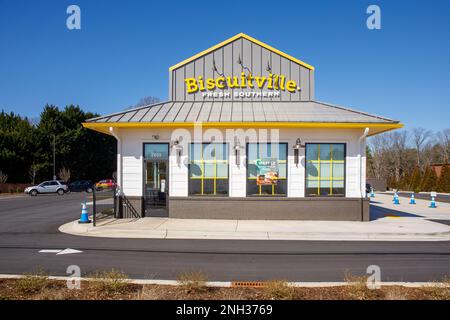 HICKORY, NC, USA-18 FEB 2023: Biscuitville restaurant de restauration rapide, vue de face, ciel bleu ensoleillé. Banque D'Images