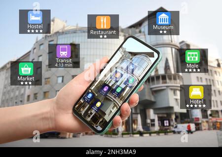 Tourisme utilisant l'application de guide en ligne sur smartphone pour la navigation en ville, de gros plan. Technologie de l'information en réalité augmentée Banque D'Images