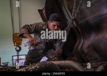 ÉTATS-UNIS Le mécanicien de l'armée place des chaînes en préparation au levage d'un moteur sur la caserne Schofield, Hawaï, 20 juillet 2022. Les mécaniciens ont été chargés de remplacer le moteur du véhicule. Banque D'Images