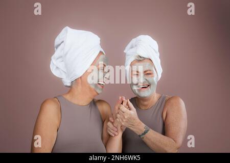 Portrait d'amis aînés heureux avec masque facial, soin de soi et concept de routine de peau. Banque D'Images