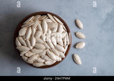 Un bol plein de graines de citrouille, vue de dessus Banque D'Images