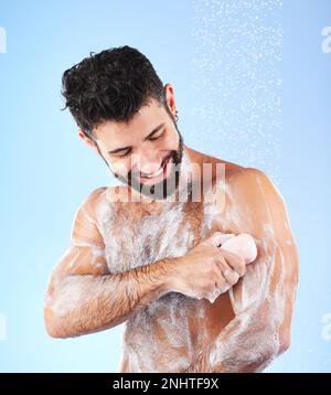 Savon, douche et homme avec des éclaboussures d'eau, sourire et hygiène en studio pour le bien-être, le nettoyage et le toilettage. Soin de la peau, peau saine et heureux homme avec Banque D'Images