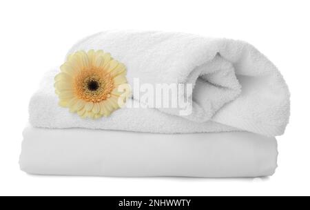 Serviettes propres, draps et gerbera sur fond blanc Banque D'Images