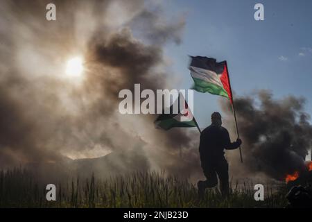 Gaza, Palestine. 22nd févr. 2023. La jeunesse palestinienne a mis le feu à des pneus en caoutchouc sur les frontières orientales de la bande de Gaza, pour exprimer sa colère contre l'armée israélienne qui a tué 10 Palestiniens cet après-midi à Naplouse. (Credit image: © Saher Elghorra/TheNEWS2 via ZUMA Press Wire) USAGE ÉDITORIAL SEULEMENT! Non destiné À un usage commercial ! Banque D'Images