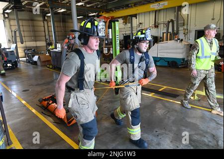 ÉTATS-UNIS Le sergent d'état-major de la Force aérienne Jason Mitchell et le sergent d'état-major Cody Miller, pompiers de l'Escadron de génie civil du 167th septembre, transportent une victime simulée d'un tireur actif pendant un scénario d'entraînement à l'escadre du transport aérien du 167th, Martinsburg (Virginie-Occidentale), le 7 août 2022. Les victimes simulées portent une étiquette pour communiquer leur état aux premiers intervenants à leur arrivée. (Photo de la Garde nationale aérienne par l'homme d'aviation principal Steven Sechler) Banque D'Images