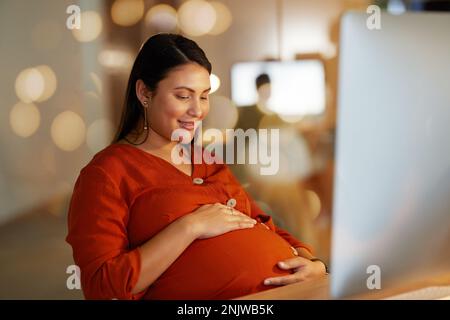 Femme enceinte, estomac et d'affaires au bureau sur ordinateur excité, heureux et sourire pour bébé. Travail d'entreprise, grossesse et main-d'œuvre féminine Banque D'Images