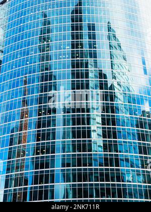Vue avant de la façade en verre de la tour avec reflet des gratte-ciels dans le quartier de Moscou Banque D'Images
