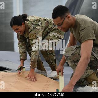 ÉTATS-UNIS Airman Amanda, principal de la Force aérienne, à gauche, et Robert, principal Airman, deux compagnons observables bas du 1st Escadron de maintenance, préparent un F-22 Raptor pour la peinture à la base conjointe Langley-Eustis, en Virginie, le 11 août 2022. LO est l’un des neuf vols le MXS 1st est composé de qui fournissent des services de soutien à la flotte de F-22s de l’escadre 1st. Banque D'Images