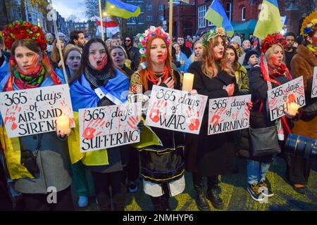 Londres, Royaume-Uni. 24th févr. 2023. Les manifestants portant des couvre-fleurs tiennent des bougies et des pancartes anti-guerre pendant la manifestation devant l'ambassade de Russie. Des milliers de personnes ont défilé de Holland Park à l'ambassade de Russie au cours d'une manifestation pro-ukrainienne à l'occasion du premier anniversaire de l'invasion russe. (Photo de Vuk Valcic/SOPA Images/Sipa USA) crédit: SIPA USA/Alay Live News Banque D'Images