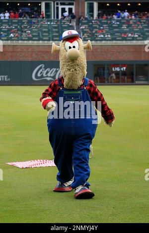 ATLANTA, GA - JULY 31: Braves mascot Blooper fools around with Willy Adames  #27 of the Milwaukee Brewers before the Saturday evening MLB game between  the Atlanta Braves and the Milwaukee Brewers