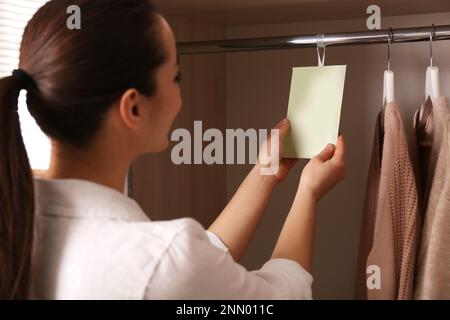 Jeune femme tenant un sachet parfumé dans une armoire Banque D'Images