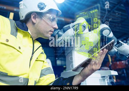 contrôle mâle d'ingénieur faire fonctionner la technologie avancée robotique dans l'automatisation usine concept de l'industrie de l'effet visuel hologramme Banque D'Images