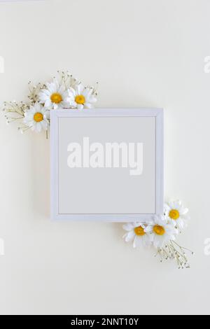 vue de dessus cadre vierge décoré de fleurs blanches sur fond blanc. Belle photo Banque D'Images