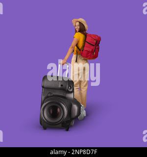 Bonne jeune femme européenne en chapeau avec sac à dos marche avec énorme valise photo Banque D'Images