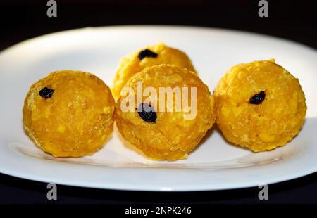 Gros plan image de Laddoo jaune doux indien sur fond blanc Banque D'Images