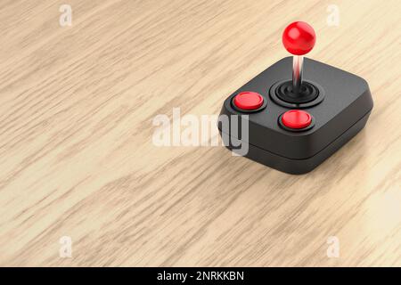 Joystick rétro noir sur bureau en bois Banque D'Images