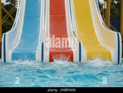 Toboggans colorés près de la piscine dans le parc aquatique Banque D'Images