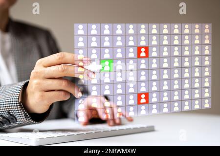 Responsable des ressources humaines travaillant avec la base de données numérique des employés pour marquer les employés à potentiel élevé et faible. Banque D'Images