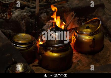 Quelques théières avec thé bédouin, bouilloire sur feu de camp la nuit, Jordanie, Wadi Rum Banque D'Images