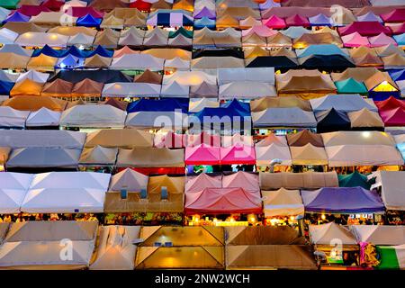 Gros plan de rangées de tentes colorées et de stands de nourriture au coucher du soleil. Banque D'Images