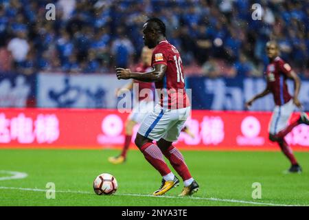 Cameroonian football player Christian Bassogog of Henan Jianye dribbles the ball against Shanghai Greenland Shenhua in their 24th round match during the 2017 Chinese Football Association Super League (CSL) in Shanghai, China, 10 September 2017.(Imaginechina via AP Images)