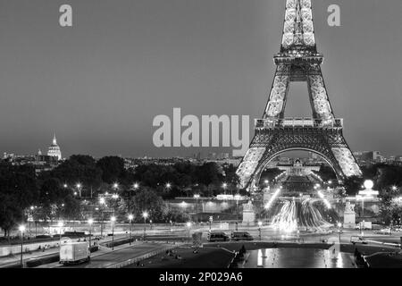 Feux de signalisation menant à une Tour Eiffel illuminée la nuit à Paris, France Banque D'Images