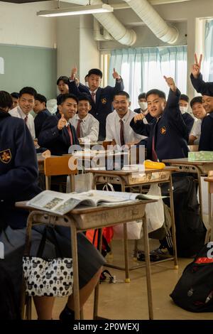 Les élèves du secondaire qui fréquentent l'école secondaire Naha Nishi posent pour une photo de groupe à Naha City, Okinawa, Japon, le 1 février 2023. L'école secondaire Naha Nishi a accueilli des étudiants et du personnel de l'école secondaire Kubasaki pour faire l'expérience d'une culture et d'un environnement différents. Les élèves et le personnel de l'école secondaire Kubasaki ont visité le campus et ont eu l'occasion de s'asseoir pour des cours de physique, de chimie et d'anglais. Au cours des cours, les étudiants américains et japonais ont réalisé ensemble des tâches, des activités et des feuilles de travail, et ont terminé leur journée avec des boîtes à bento pour le déjeuner. Il s'agit d'un événement annuel coordonné entre les deux Banque D'Images