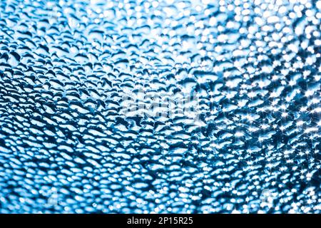 Résumé bleu bokeh goutte d'eau cercle texture d'arrière-plan avec zones hors foyer. Banque D'Images