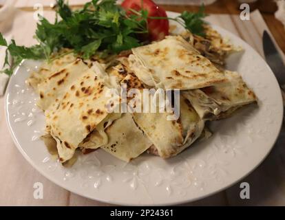 Cuisine turque traditionnelle, gozleme de crêpes turques avec fromage et herbes. Le pain plat est une pâtisserie turque. Il y a des variétés comme la pomme de terre, les épinards. Banque D'Images