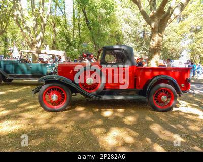 Vieux pick-up Chevrolet rouge et noir 1929 de GM sous les arbres. Autoclasica 2022 Classic car show. CopySpace. Vue latérale. Banque D'Images