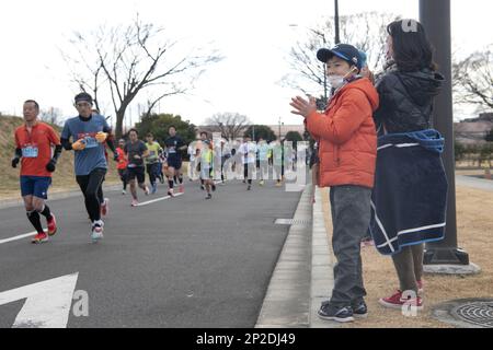 Les spectateurs applaudissent aux coureurs du semi-marathon lors de la course annuelle Frostbite Road 42nd à la base aérienne de Yokota, Japon, le 22 janvier 2023. Il s'agit de la première course de Frostbite Road à la base aérienne de Yokota en trois ans, et elle est classée parmi les 100 courses sur route les plus populaires au Japon. L'événement est une occasion pour Yokota et les communautés locales japonaises de profiter de la pratique de la forme physique ensemble et contribue à renforcer le partenariat durable que les deux nations partagent. Banque D'Images