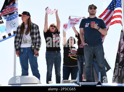 08 Mar. 2015: NASCAR fans watching the Sprint Cup Series 18th Annual Kobalt 400 from the roof of a motorhome in the infield raise their Jeff Gordon 24 flags during the 24th lap raced at the Las Vegas Motor Speedway in NV. (Icon Sportswire via AP Images)