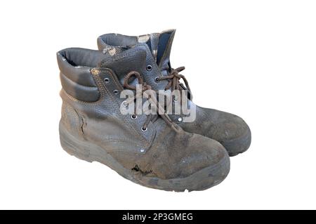 Une paire de bottes de travail brunes anciennes et usées Banque D'Images