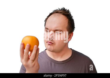 Portrait d'un homme adulte avec un fruit orange dans la main, isolé sur un fond blanc Banque D'Images