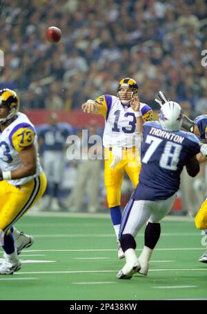 JANUARY 30 2000: Rams quarterback Kurt Warner (13) tries to avoid Titans  defense end Jevon Kearse as the St. Louis Rams defeated the Tennessee  Titans 23-17 to win Super Bowl XXXIV at