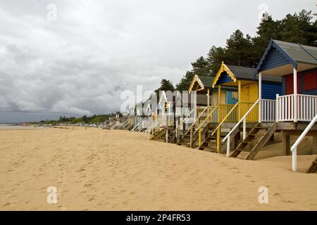 Cabanes de plage peintes en couleurs à Holkham Bay près de Wells by the Sea, North Norfolk, Angleterre. La plage de sable et les cabanes de cartes postales sont des vacances populaires Banque D'Images