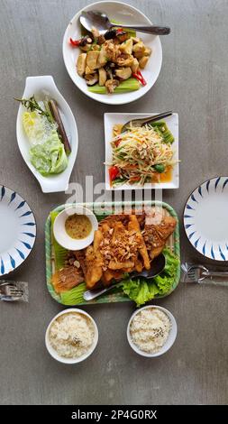 Une table avec la cuisine thaïlandaise de campagne d'Isaan en Thaïlande dans la soirée Banque D'Images