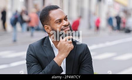 Gros plan portrait homme ethnique barbu à l'extérieur homme d'affaires afro-américain regardant loin penser à l'avenir pensez entrepreneur pensif réfléchi dans Banque D'Images